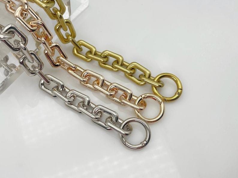 May include: Three chain links in gold, rose gold, and silver with a clasp on each end.