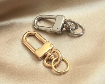 Moschettone girevole a forma di U lucido con anellino di congiunzione, accessorio per portachiavi con chiusura a moschettone.