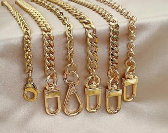 May include: A collection of six gold-toned metal chains of varying link styles and thicknesses, each finished with a different gold-toned metal clasp, including lobster claw, swivel, and rectangular spring-gate designs for attachment.