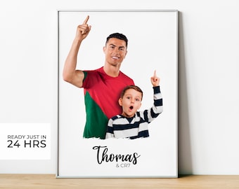 May include: A white framed print with a photo of a man and a young boy, both pointing upwards. The man is wearing a red and green jersey and the boy is wearing a striped shirt. The text "Thomas & CR7" is written below the photo.