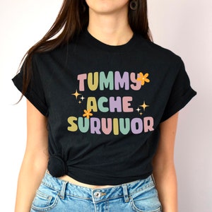 Tummy Ache Survivor Unisex T Shirt | Mental Health Awareness Matters | Floral Twinkle | Pastel Gift | Stomach Ache Pain