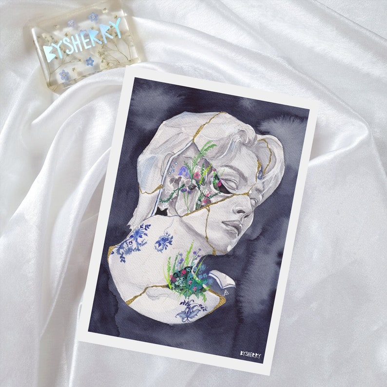 May include: A watercolor painting of a broken plaster bust with flowers growing from the cracks. The bust is a portrait of a person with their eyes closed. The background is a dark blue color.