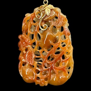 A Qing Dynasty, Squirrel and Grapes Jadeite Pendant