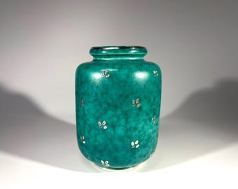 May include: A teal ceramic vase with a silver metallic glaze and a scattered pattern of silver leaves.