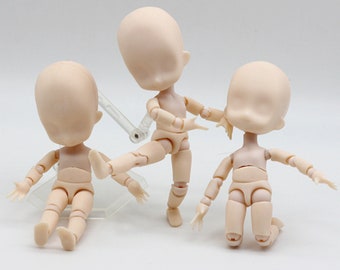 May include: Three unpainted, articulated, plastic doll figures with posable limbs and heads. The dolls are in various poses, with one sitting, one standing, and one kneeling.