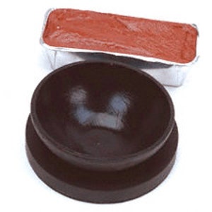 May include: A red wax block in a silver foil container and a brown ceramic bowl with a black base.