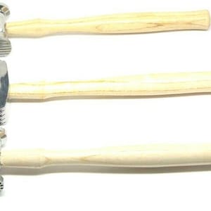 May include: Three metal hammers with wooden handles. The hammers have different textured heads.