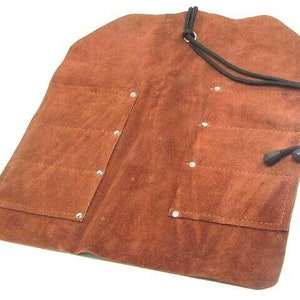 May include: Brown leather tool roll with multiple pockets and a drawstring closure.