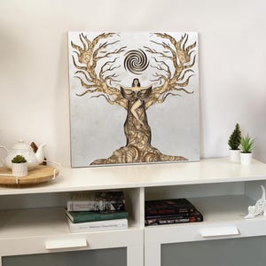 Handcrafted feminine energy art piece in light-toned wood, displayed on a neutral wall for a calm interior setting
