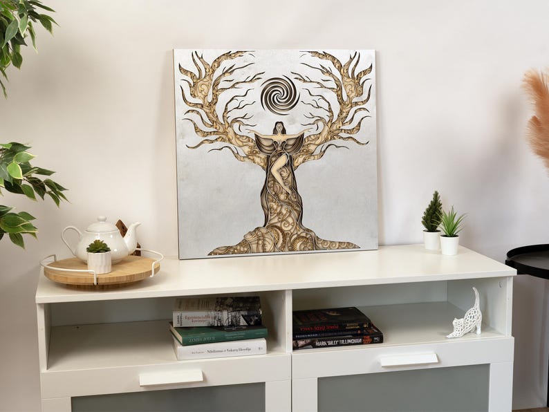 Handcrafted feminine energy art piece in light-toned wood, displayed on a neutral wall for a calm interior setting