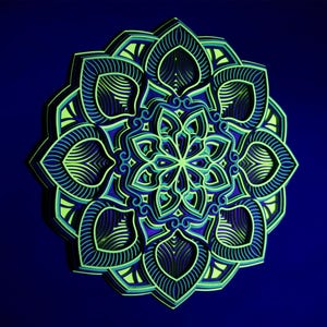 Puede incluir: Un mandala de capas verdes y azules con intrincados patrones. El mandala está hecho de papel y tiene un efecto 3D.