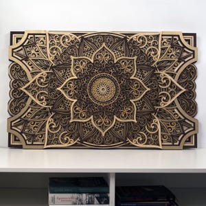 Wooden mandala wall hanging displayed as a statement piece above a sofa in a cozy living room setting