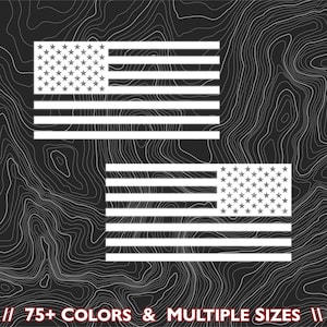 May include: Two white American flags are displayed against a dark, textured background. The flags feature white stars in a blue rectangle and white stripes. The text at the bottom reads "75+ COLORS & MULTIPLE SIZES".