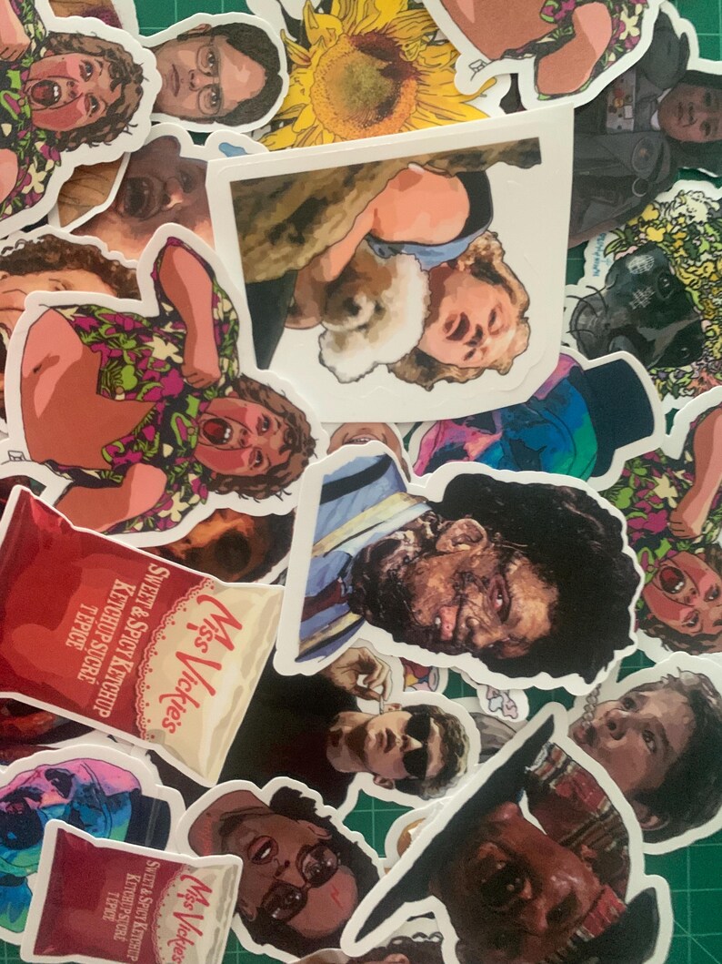 May include: A collection of colorful stickers featuring various characters and designs. The stickers include a sunflower, a cartoon character with a red shirt, a chip bag, and a character with a blue shirt and a bandage on their face.