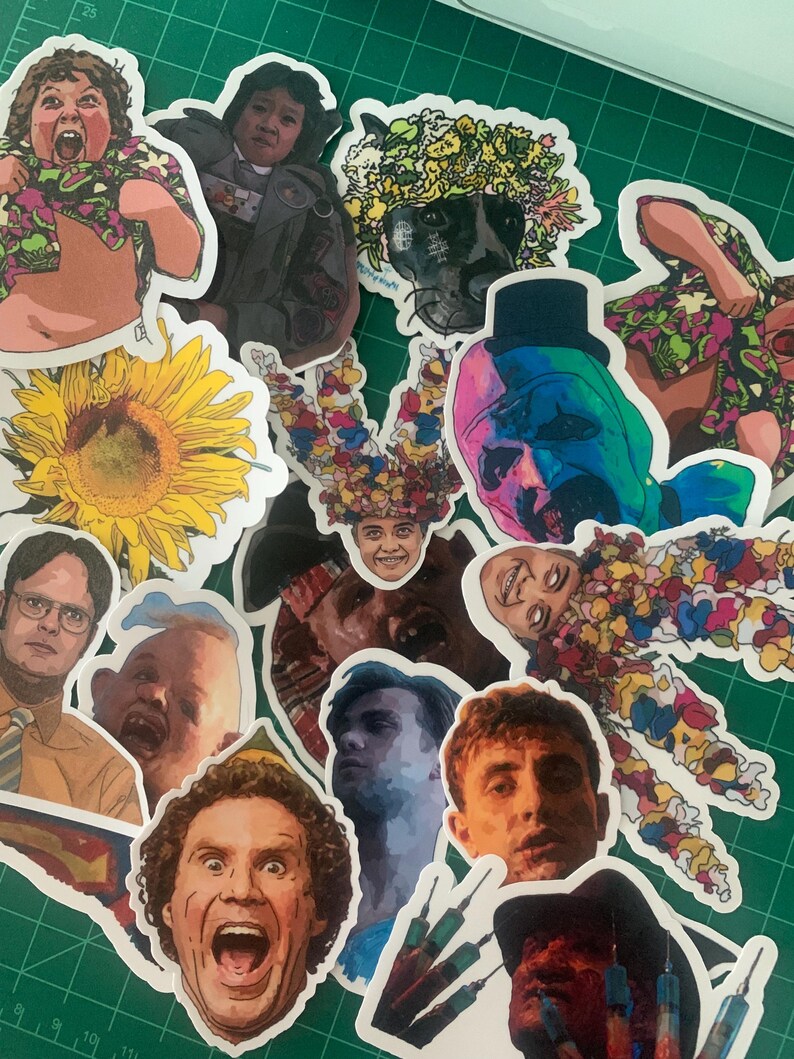 May include: A collection of colorful stickers featuring various characters and designs. The stickers include a sunflower, a character from the movie 'The Shining', a character from the movie 'The Office', and a character from the movie 'The Wolf of Wall Street'.
