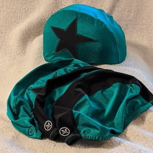 May include: Three teal green and black fabric head coverings with a black star on the top one. The head coverings have a size 'M' label on the side.