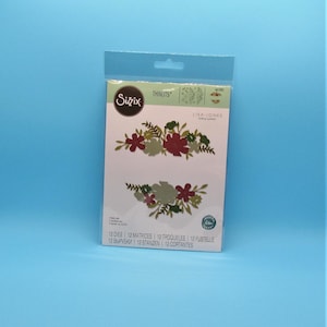 May include: A pack of Sizzix Thinlits dies featuring two floral designs by Lisa Jones. The dies are for use with a die-cutting machine and are designed to create intricate floral embellishments for cards, scrapbook pages, and other paper crafts.