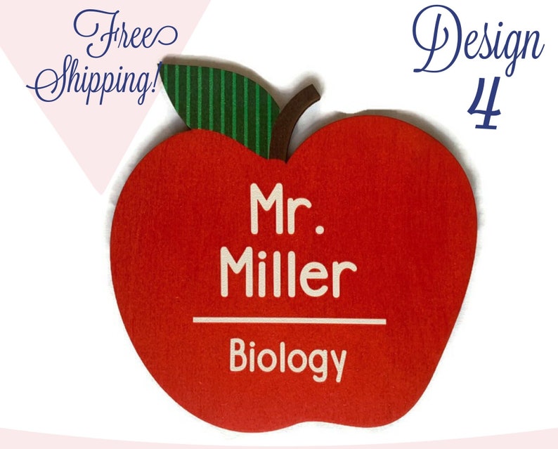 May include: Red apple-shaped wooden teacher name tag with a green leaf. The tag says "Mr. Miller" and "Biology" in white text.