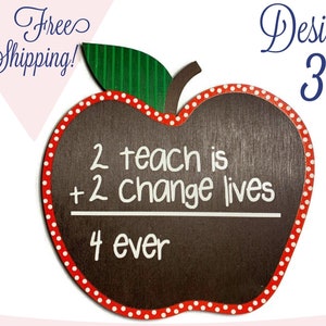 May include: Red apple-shaped chalkboard with white polka dots around the edge. The chalkboard has the words "2 teach is + 2 change lives" written on it with a line underneath. Below the line is the word "4 ever".