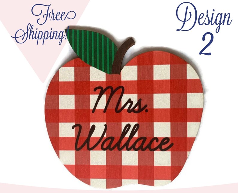 May include: Red and white checkered apple-shaped wooden sign with the text "Mrs. Wallace" in black cursive lettering.