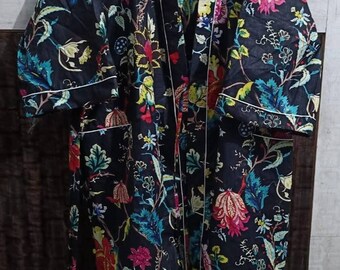 May include: A black floral robe with a white trim. The robe has a long sleeve and a tie belt.
