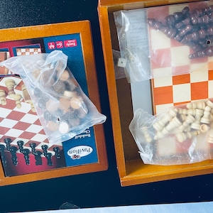 May include: Two wooden game boards with lids, each containing a chess set. One board has black and white pieces, the other has brown and white pieces. The boards are labeled "Pavilion Backgammon & Chess".