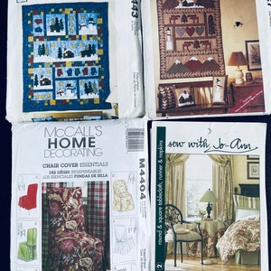 May include: Four sewing patterns for home decor projects. The patterns include a winter-themed quilt, a chair cover, and a tablecloth with napkins. The patterns are from McCall's Crafts and Sew with Jo-Ann.