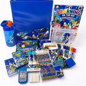 May include: A Sonic the Hedgehog themed school supply set including a blue binder, a reusable workbook, a water bottle, Crayola markers and crayons, pencils, erasers, a pencil case, and a composition book, all featuring character graphics and the name Greyson.