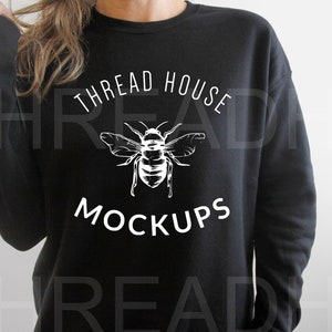 May include: Black sweatshirt with white text that reads "THREAD HOUSE" and "MOCKUPS" with a bee graphic in between the text.