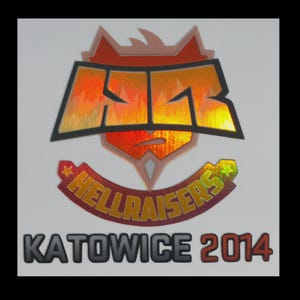 May include: A holographic sticker featuring the HellRaisers team logo with a stylized HR monogram above a banner reading HELLRAISERS and the text KATOWICE 2014 below. The design uses orange, red, and yellow metallic gradients with black outlines.