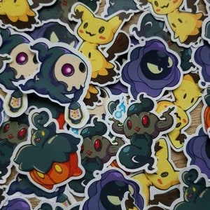 May include: A collection of colorful stickers featuring various cartoon characters. The stickers are printed on white paper and have a glossy finish. The characters include a ghost, a pumpkin, a flower, and a variety of other creatures.