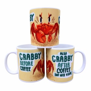 May include: Three white ceramic mugs with a cartoon crab design. The top mug has a red crab with the text "Crabby" partially visible. The middle mug has the text "Crabby Before Coffee". The bottom mug has the text "Also Crabby After Coffee (But With Vigor)".