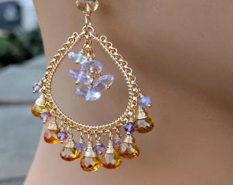 May include: Gold tone dangle earrings with a cluster of light purple amethyst stones and a fringe of teardrop shaped citrine stones.
