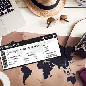May include: A black and white boarding pass with the text "Surprise! Pack Your Bags" and "You're getting off!"  The boarding pass has a flight number, date, and seat number. The text "To: Sasha, From: Justin, Special Message: Happy Birthday Babe! I Love You." is on the boarding pass.
