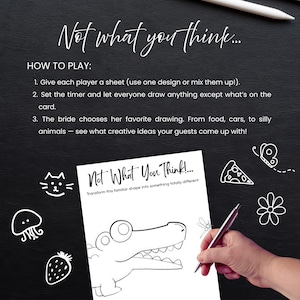 May include: A black background with white text that reads "Not what you think..." and "How to play:". A sheet with a crocodile drawing is being drawn on with a pen. The text "Not What You Think!" is also visible.