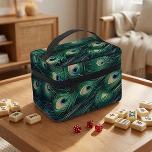A colorful lunch bag with a peacock feather pattern sits on a wooden table, surrounded by playing cards and red dice.