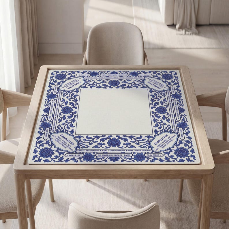 a square table with a blue and white floral patterned tablecloth, surrounded by four chairs.