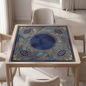 a square table with a blue and gold patterned tablecloth, surrounded by four chairs.