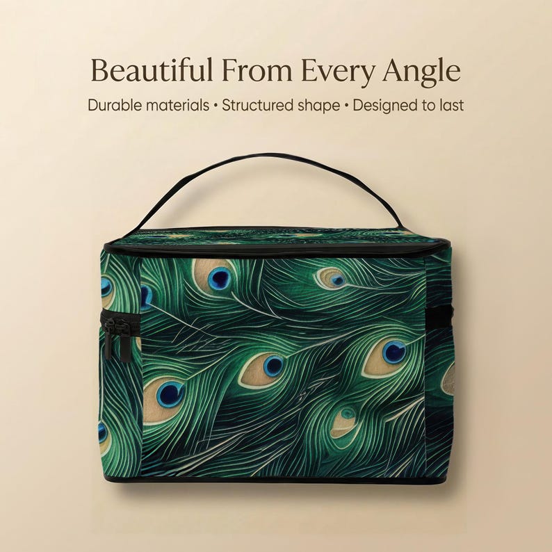A large, rectangular cosmetic bag with a pattern of green and blue peacock feathers on it.
