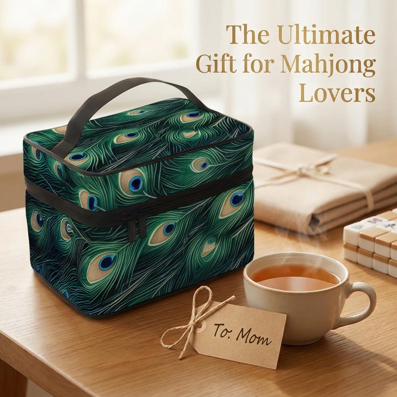 a gift for Mahjong Lovers, including a colorful insulated lunch bag with a peacock feather pattern, a cup of tea, and a card addressed to "To Mom".