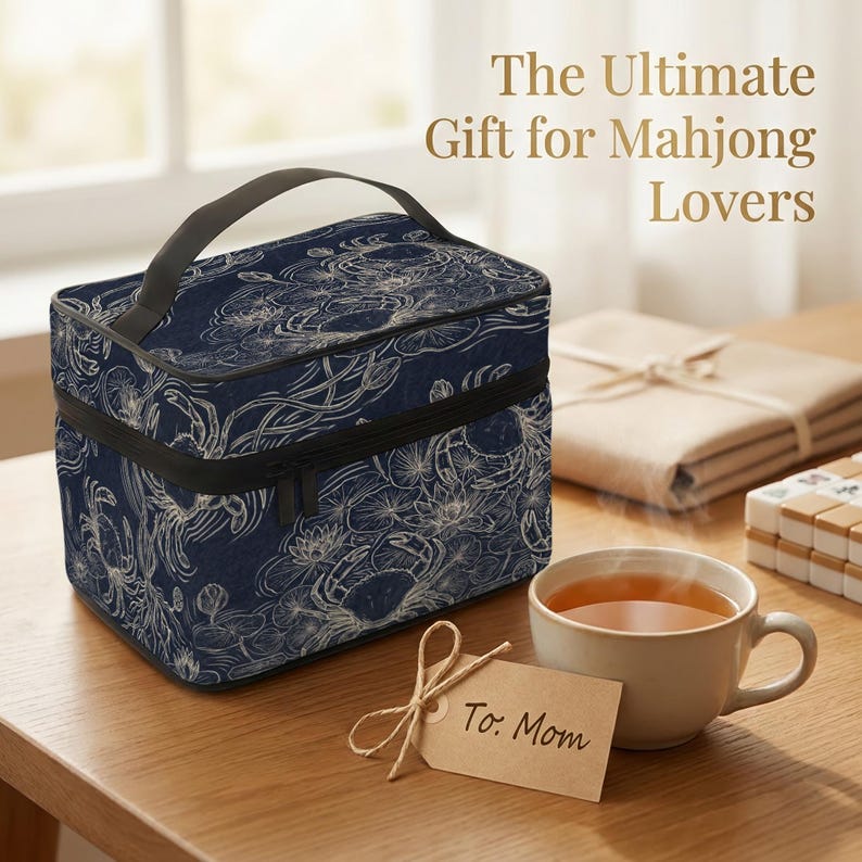a blue and white floral bag, a cup of tea, and a card with a message for a mother, all placed on a wooden table.