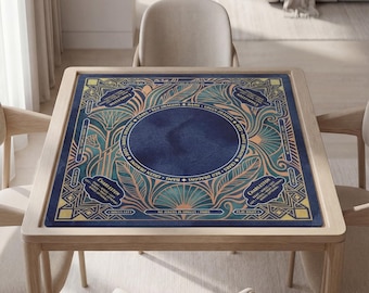 May include: A square mahjong table mat featuring a dark blue center circle surrounded by intricate teal and gold art deco patterns. The border includes text labels for Charleston, Dots, Bams, Cracks, Red Dragons, Green Dragons, and White Dragons.
