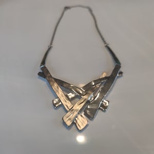 Stainless steel necklace, beautiful matte finish and glossy silver color with integrated chain, intersecting steel plates, impeccable