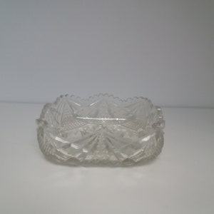 May include: A clear glass square dish with a cut glass design.