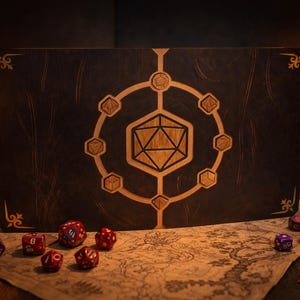 Può includere: Un tabellone di gioco in legno marrone scuro con un design geometrico al centro, circondato da dadi. Una candela e una lanterna accese sono sullo sfondo, creando un'atmosfera calda. Il tabellone è appoggiato su una mappa.