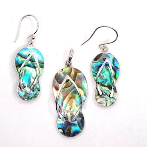 May include: A set of silver earrings and a pendant featuring a flip-flop design with iridescent abalone shell inlay.