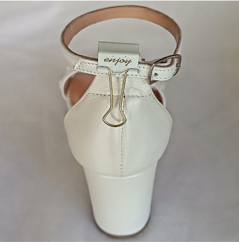 White leather handmade block heel sandal with a block heel and ankle strap. The heel is approximately 2 inches high.