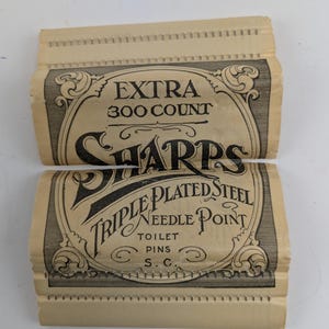 May include: A vintage paper package of Sharps Triple Plated Steel Needle Point Toilet Pins, with a black and white design and the text "Extra 300 Count" and "S.C."
