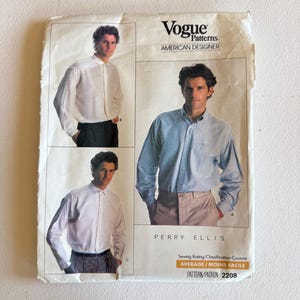 May include: A Vogue Patterns sewing pattern envelope for a Perry Ellis shirt, labeled 2208. The front features three photographs of a shirt in different colors and styles, with the text Vogue Patterns, American Designer, and Average/Moins Facile.