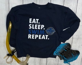 Eat. Sleep. Swim. Repeat. Sweatshirt pullover Youth unisex for Boys and girls with a swimmer graphic Navy blue